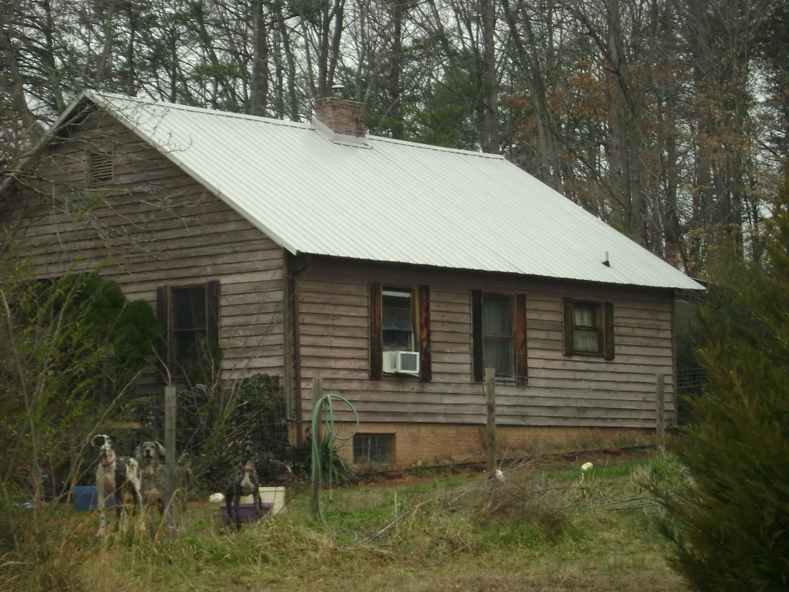 White metal roof on an old wood sided farmhouse, from a Metal Roof Installation job in Santo Domingo Pueblo